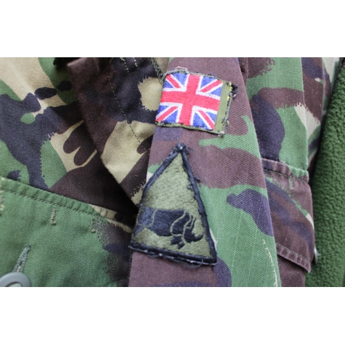 147 - Three camouflage Army Jackets, NATO Fleece, various packs, shirts, braces etc