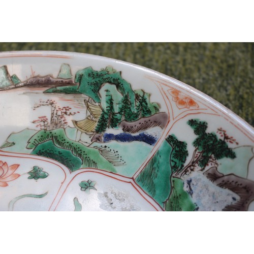 42 - Chinese Kangxi Charger with central floral medallion flanked by Rocky outcrops and lined rim, to rev... 