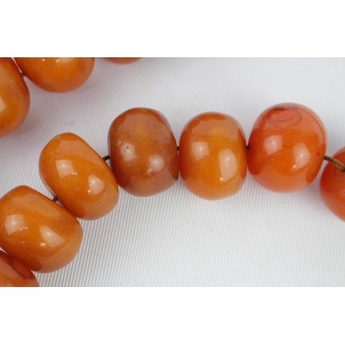 267i - Very Large Amber bead necklace, comprising 18 Eighteen butterscotch amber beads measuring 48cm in Le... 