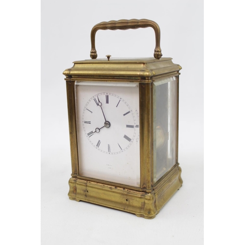 73 - A late 19thC Brass carriage clock, with white enamel dial signed Dent, quarter repeating with carria... 