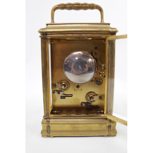 73 - A late 19thC Brass carriage clock, with white enamel dial signed Dent, quarter repeating with carria... 