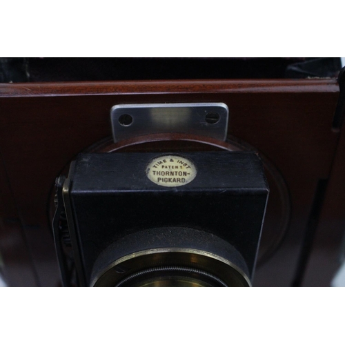 129 - A Victorian Thornton Pickard mahogany triple-plate camera with plates and tripod & Ross of London Ze... 