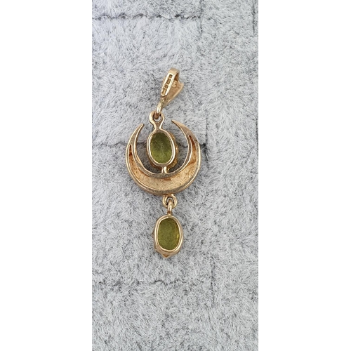 417 - Edwardian 9ct Gold Peridot and Seed pearl set Crescent drop pendant. 3cm in Length. 1.7g total weigh... 