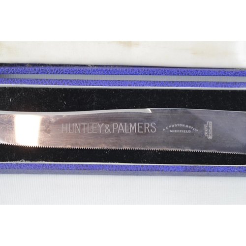 323 - Boxed Huntley & Palmers Cake knife with Silver plated handle