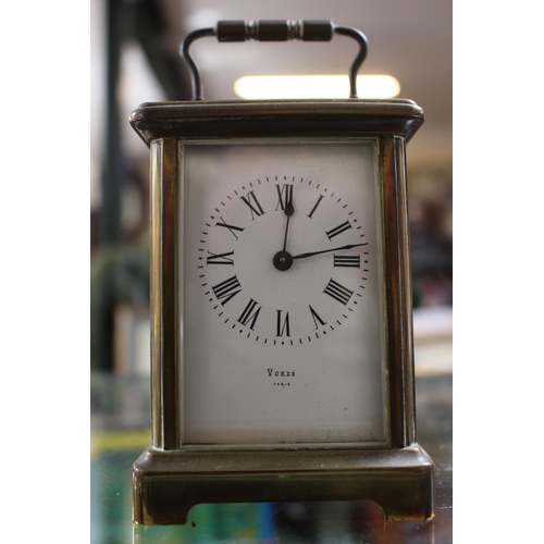 240 - Voked of Paris Brass cased Carriage clock with roman numeral dial with key