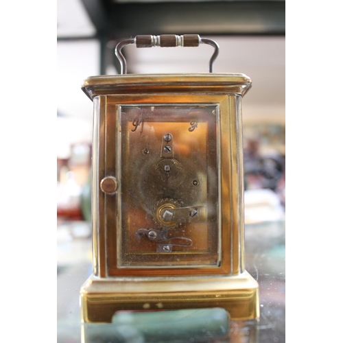 240 - Voked of Paris Brass cased Carriage clock with roman numeral dial with key