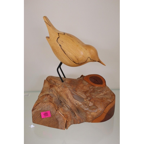 73 - Bruno Sharron, The Wood Studio carving of bird on a log . 20cm in Height