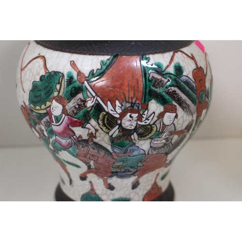 76 - Large Crackle glaze lidded Vase with figural decoration. 26cm in Height