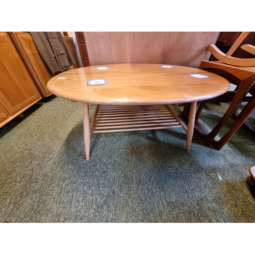 283 - Ercol Blonde Elm Oval Coffee table with magazine rack to under tier on tapering legs