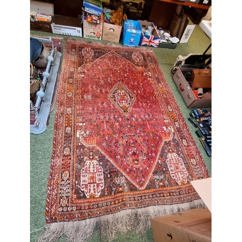 319 - Large Red Ground Persian Rug with knotted tassels