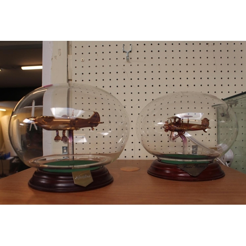 10 - 2 glass models of Aircraft in glass domes on wooden bases Spitfire & Bristol Bulldog