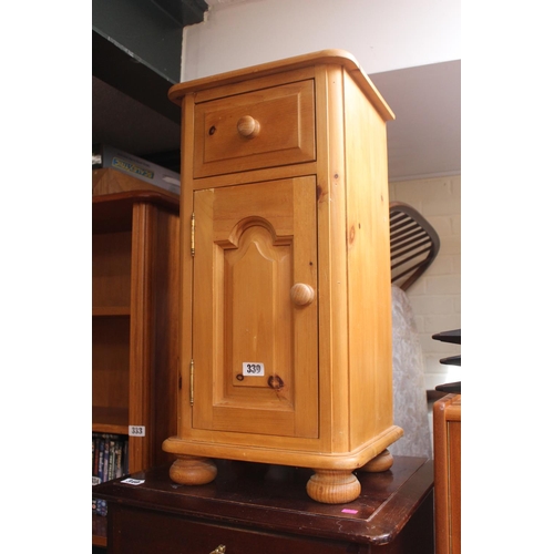 339 - Pine Bedside cabinet with panelled door on bun feet