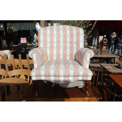 383 - Modern Elbow chair on turned legs with brass casters