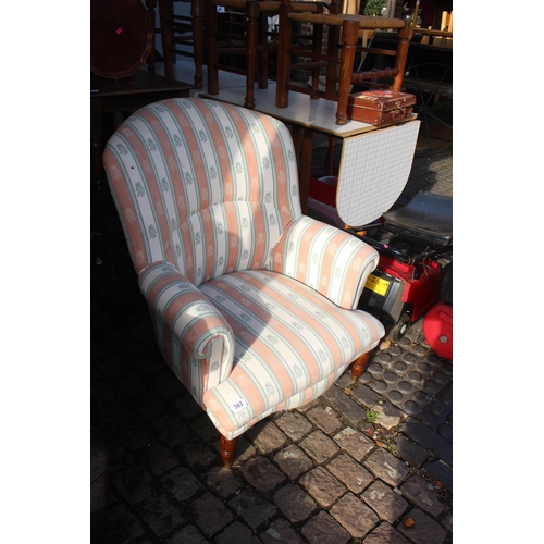 383 - Modern Elbow chair on turned legs with brass casters