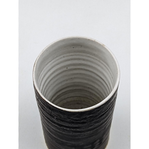 7 - Dame Lucie Rie D.B.E (1902-1995) a stoneware cylindrical vase, the exterior bronze the interior off ... 