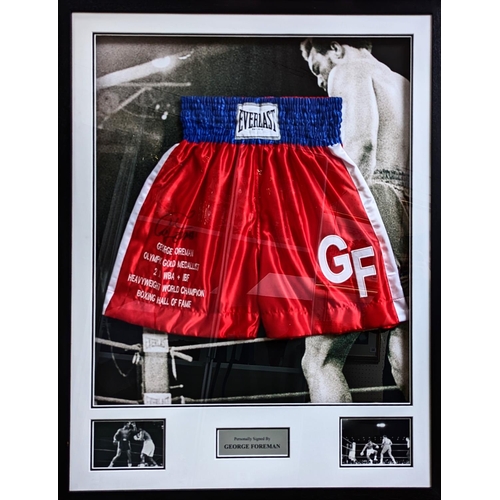 82 - George Foreman signed boxing trunks Red, White & Blue. COA to Reverse. 78 x 99cm total size