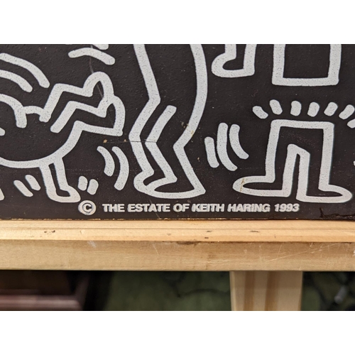 163 - Keith Haring (1959-1990) hanging black board decorated with his iconic pop art stick figures from th... 