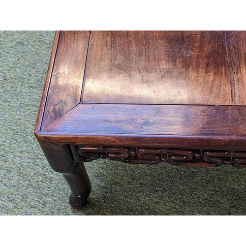 211 - A CHINESE HUANGHUALI LOW TABLE CIRCA 1900
The square top with inset plank panel over carved pierced ... 