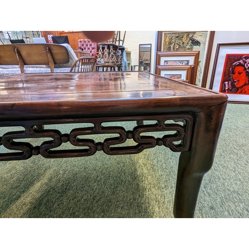 211 - A CHINESE HUANGHUALI LOW TABLE CIRCA 1900
The square top with inset plank panel over carved pierced ... 