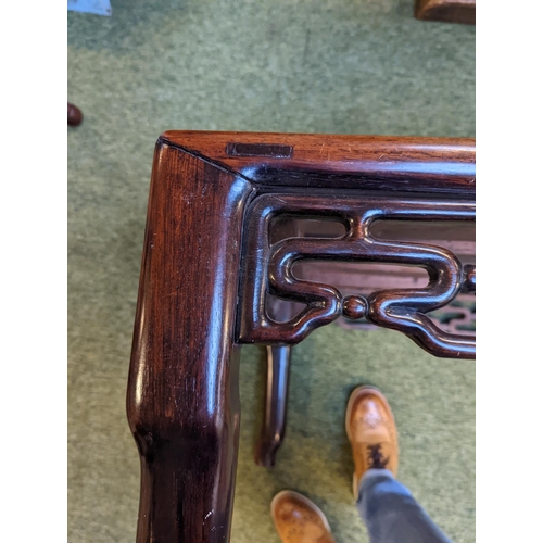 211 - A CHINESE HUANGHUALI LOW TABLE CIRCA 1900
The square top with inset plank panel over carved pierced ... 