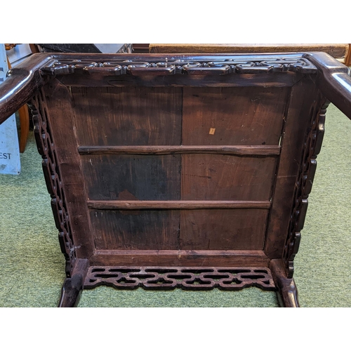 211 - A CHINESE HUANGHUALI LOW TABLE CIRCA 1900
The square top with inset plank panel over carved pierced ... 