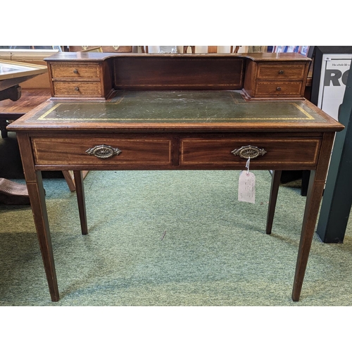 221 - Edwardian green leather topped Ladies' desk of 2 drawers with brass drop handles over tapering legs.... 