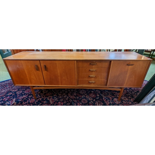 292 - 1970s Long Danish type sideboard of 4 drawers flanked by cupboards with cup handles 206cm in Length