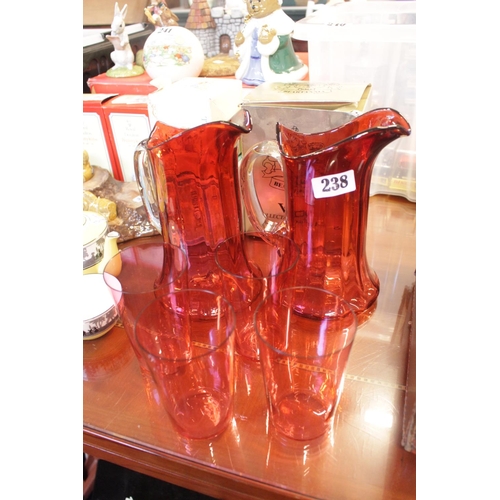 238 - Pair of Cranberry glass Water Jugs and a set of 4 Cranberry Glasses