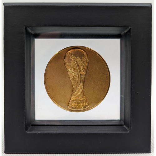 65 - A 1994 FIFA World Cup participation Medal. The obverse of the Medal features a high relief etching o... 