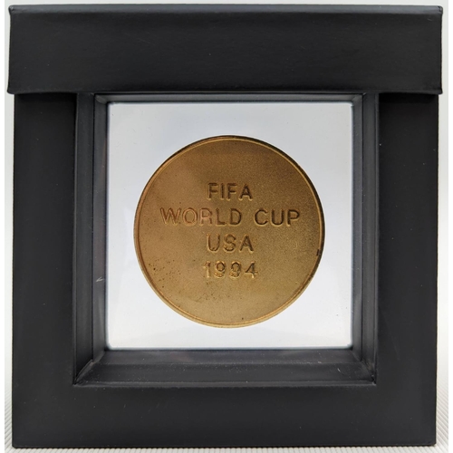 65 - A 1994 FIFA World Cup participation Medal. The obverse of the Medal features a high relief etching o... 