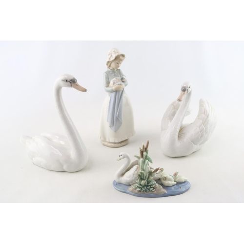 78 - 2 Lladro Swans, Lladro Swan and cygnets and a Nao figure of a woman with Puppy