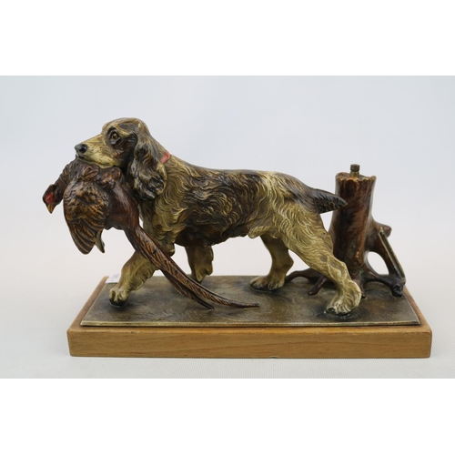 66 - Cold Painted table lighter in the form of a Springer Spaniel with Pheasant in mouth mounted on woode... 