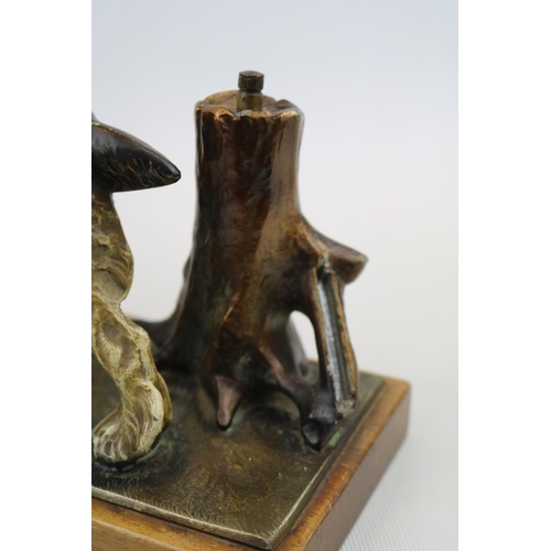 66 - Cold Painted table lighter in the form of a Springer Spaniel with Pheasant in mouth mounted on woode... 