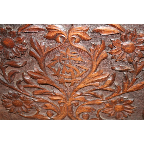 282 - Oak Carved magazine rack with floral decoration supported on scroll feet