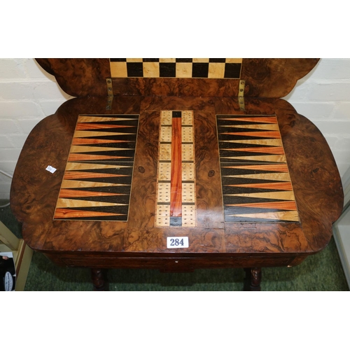 284 - Good quality Victorian games table with quartered veneer, inlaid to interior and sewing base over tu... 