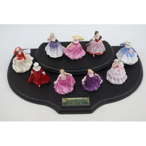 77 - Collection of 9 Royal Doulton Miniature Figurines on wooden stand