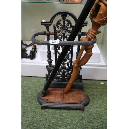 25 - Cast Iron Stick Stand with drip tray, Mallard handled stick and a African carved Stick