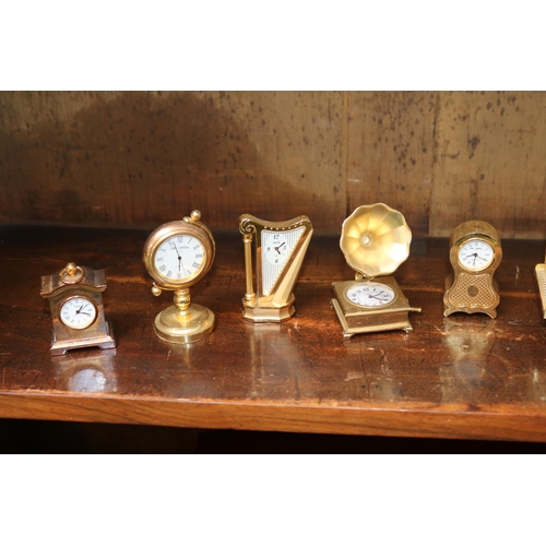 118 - Collection of 12 gilt miniature clocks in various forms.