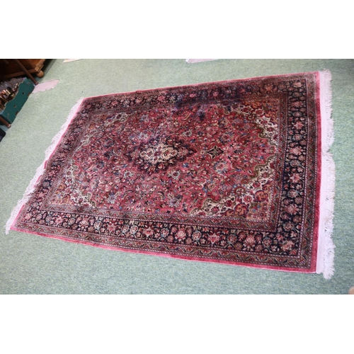 420 - Good quality Silk Red ground rug with central medallion and tassel ends 218cm x 139cm