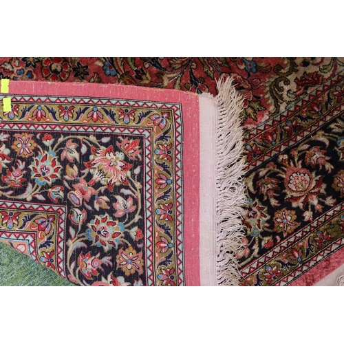 420 - Good quality Silk Red ground rug with central medallion and tassel ends 218cm x 139cm