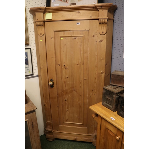 433 - Tall Stripped Pine Scorner Cabinet with fitted shelves and panelled door with applied supports