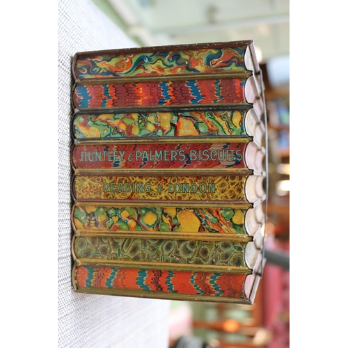 84 - Antique Huntley & Palmers biscuit tin in the form of eight bound books.