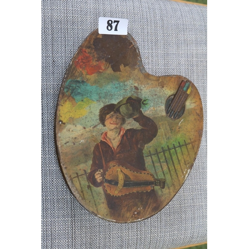 87 - Antique Huntley & Palmers biscuit tin in the form of an artists pallet also depicting an artist at w... 