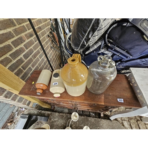 524 - 2 Stoneware foot warmers, Flagon and a Glass Demijohn