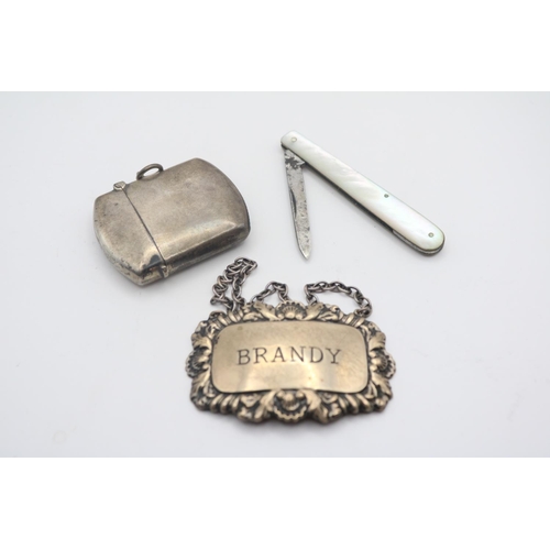 355 - Silver Brandy Label, Silver Match Vesta and a Mother of Pearl Handled Fruit Knife