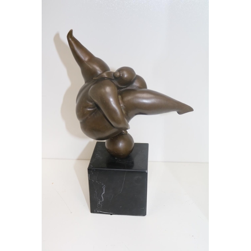 Bronze sculpture depicting a rotund lady balancing on a spherical object, mounted on slate base, signed Milo.