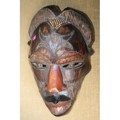 66 - Large hand carved Kenyan Tribal mask with applied metal detail. 38cm in Length