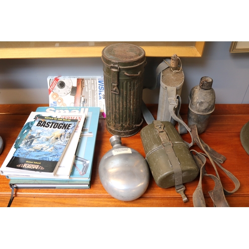 89 - WWII German Gas Mask, collection of Water bottles and assorted Books to include Small Arms, German A... 