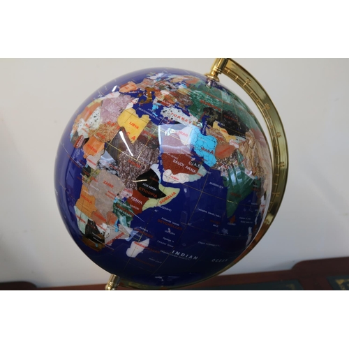 105 - Large Gemstone Semi Precious Globe with brass support over blue pedestal base. 60cm in Height