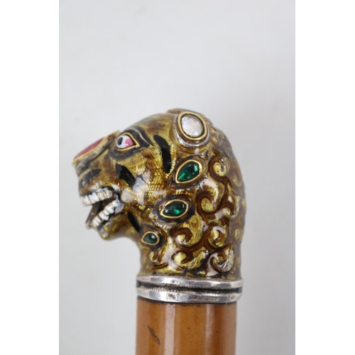 54 - Indian Gemset Silver topped walking cane modelled as a tigers head with enamelled detail mounted in ... 